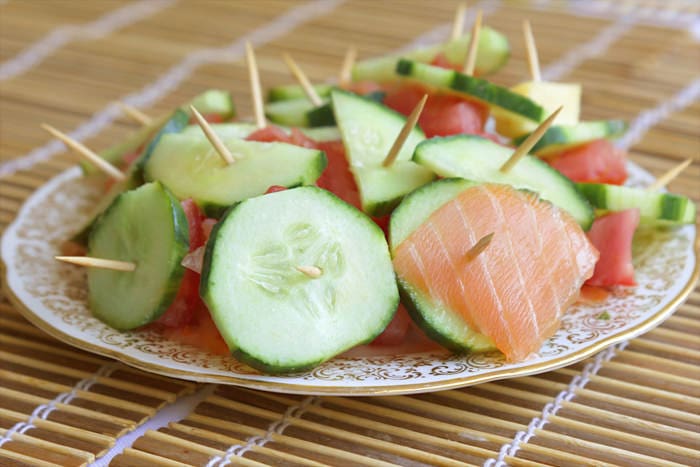 An appetizer with salmon cucumber skewers